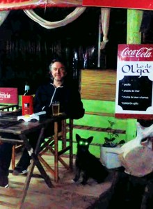 Me in a bar with a beer and a spooky-eyed dog. 